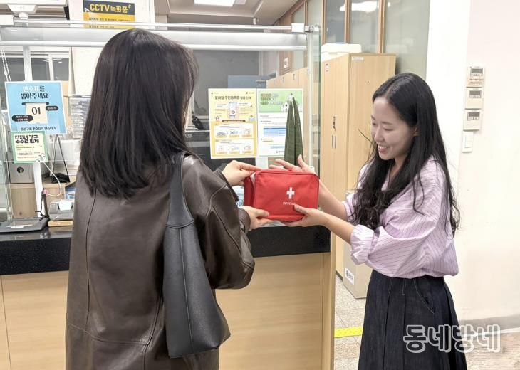 주민센터를 방문해 전입신고를 마친 청년에게 웰컴키트를 전달하고 있다